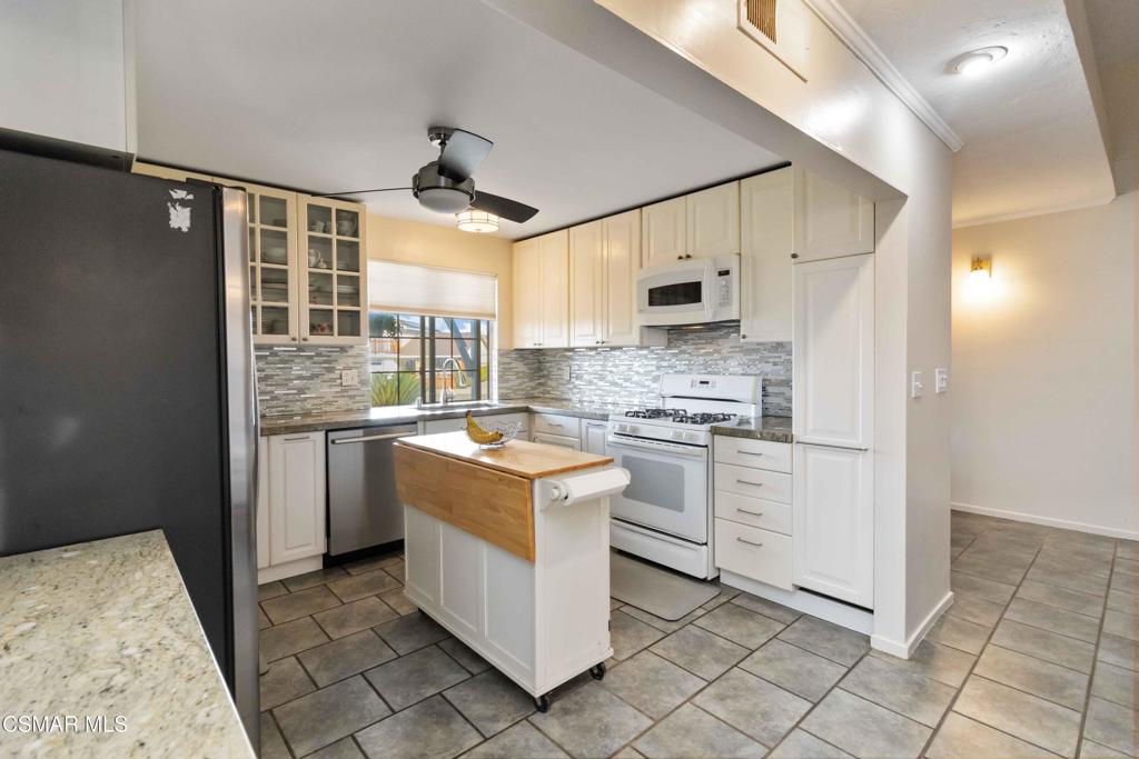 705 Wishard Avenue Simi Valley, CA 93065 - Photo 15 of 50 a kitchen with a stove a sink and a refrigerator