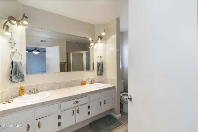 a bathroom with a double vanity sink and mirror