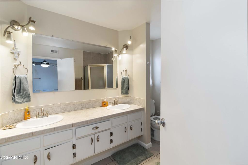 705 Wishard Avenue Simi Valley, CA 93065 - Photo 24 of 50 a bathroom with a double vanity sink and mirror