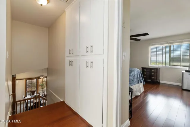 a view of a hallway and a livingroom with furniture