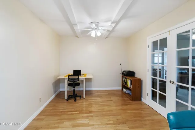 a view of a workspace with furniture and wooden floor