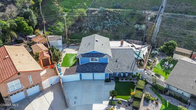 an aerial view of a house with yard and parking