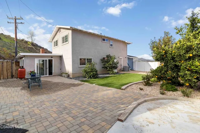 a view of a house with backyard and porch