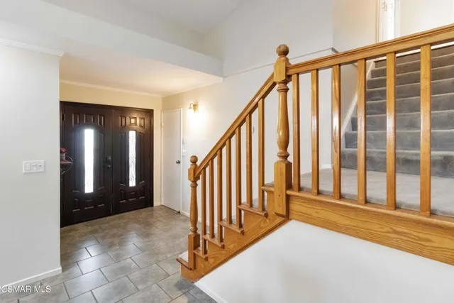 a view of a porch with wooden floor and stairs