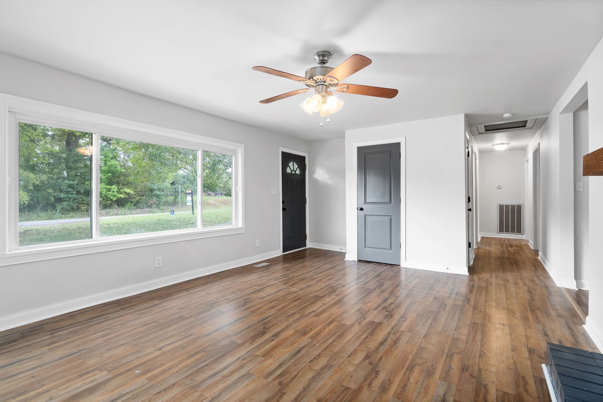 1499 North Liberty Church Road Clarksville, TN 37042 - Photo 5 of 9 a view of an empty room with wooden floor and a window