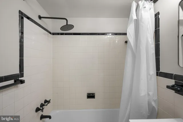 a bathroom with a shower and a bath tub