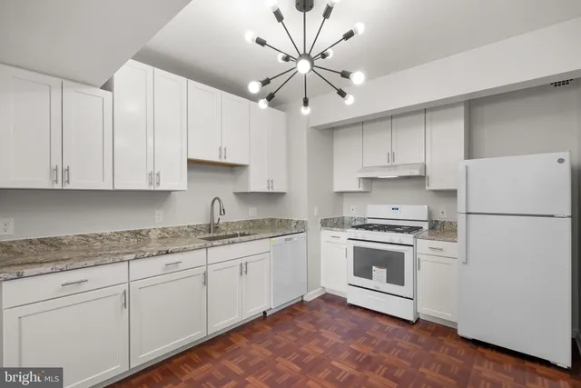 a kitchen with cabinets stainless steel appliances and a counter space