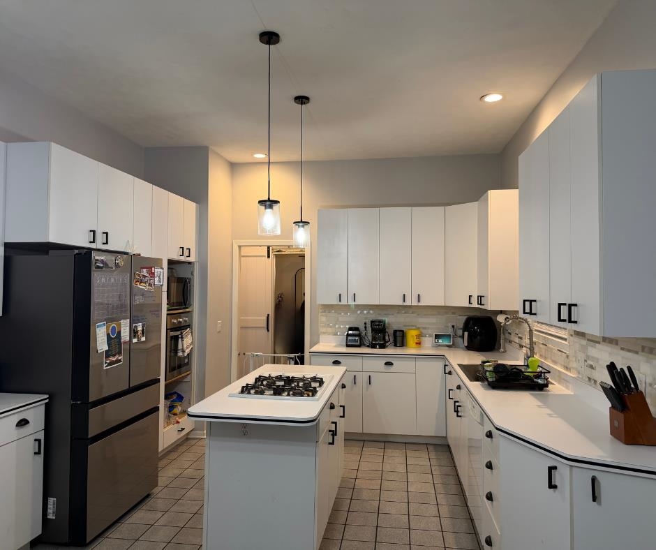 6432 Spring Hill Close Rockford, IL 61108 - Photo 13 of 13 a kitchen with refrigerator a sink and white cabinets