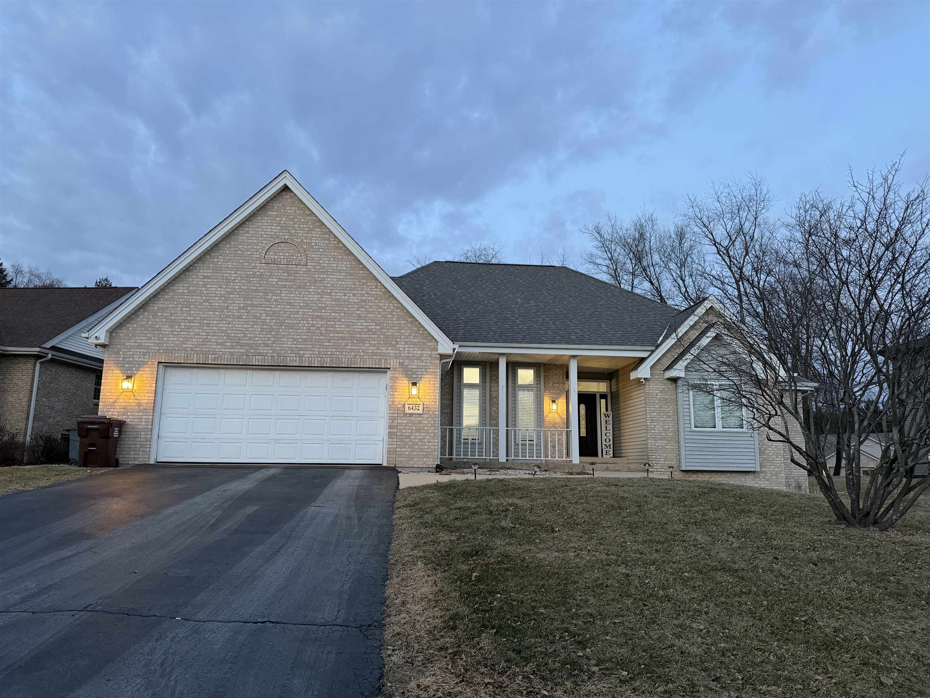 6432 Spring Hill Close Rockford, IL 61108 - Photo 10 of 13 a front view of a house with a yard and garage