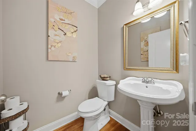 a bathroom with a sink toilet and mirror