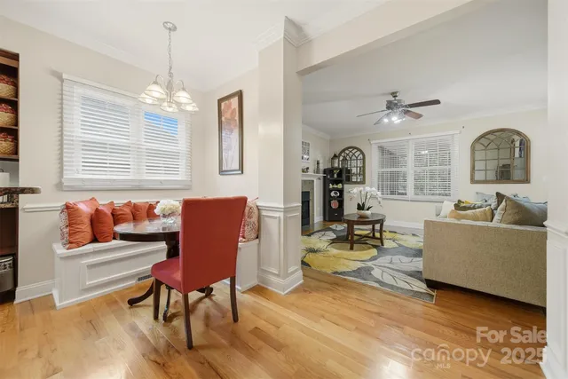 a living room with furniture chandelier and a window