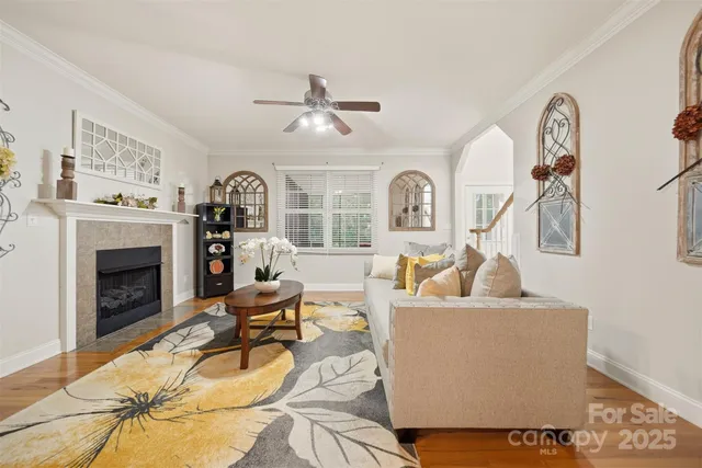 a living room with furniture a fireplace and a flat screen tv