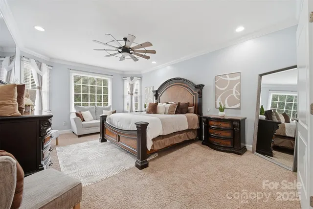 a bedroom with a bed couch dresser and window