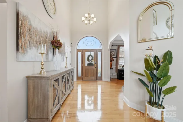 a view of living room with furniture and a chandelier