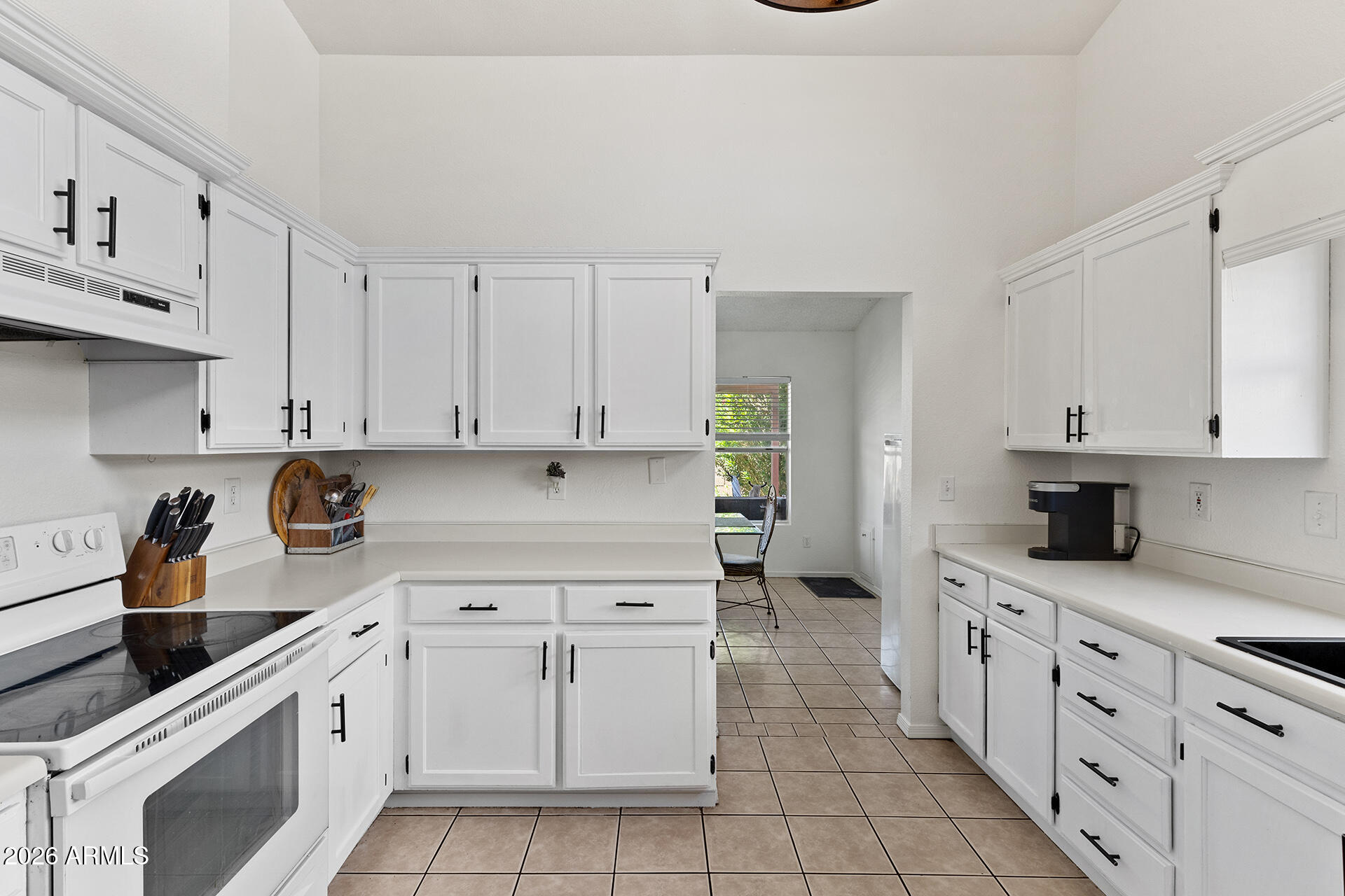 9002 West Coronado Road Phoenix, AZ 85037 - Photo 2 of 54 a kitchen with granite countertop white cabinets and white appliances
