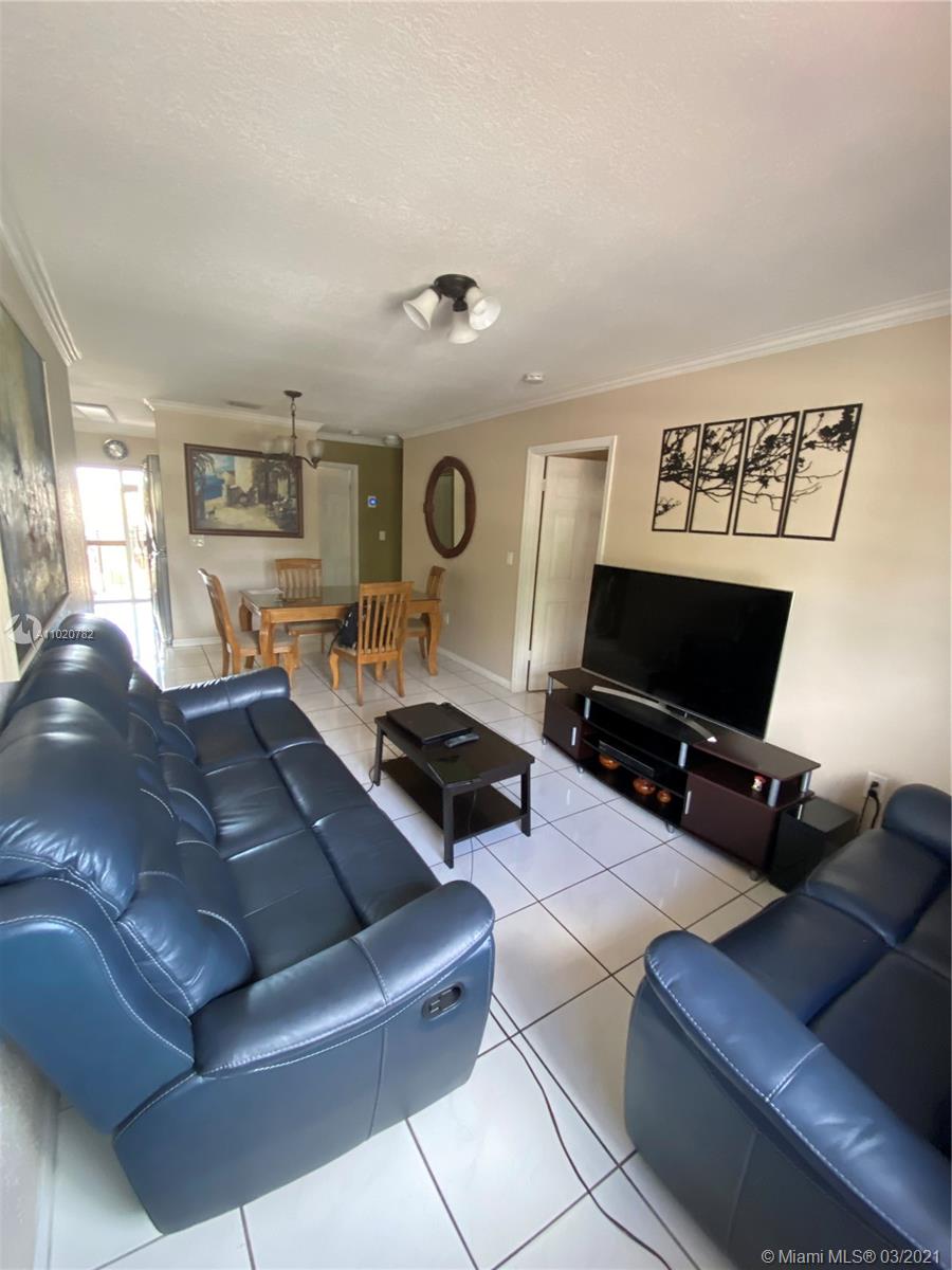 3526 West 76th Street, Unit 203 Hialeah, FL 33018 - Photo 11 of 30 a living room with furniture and a flat screen tv