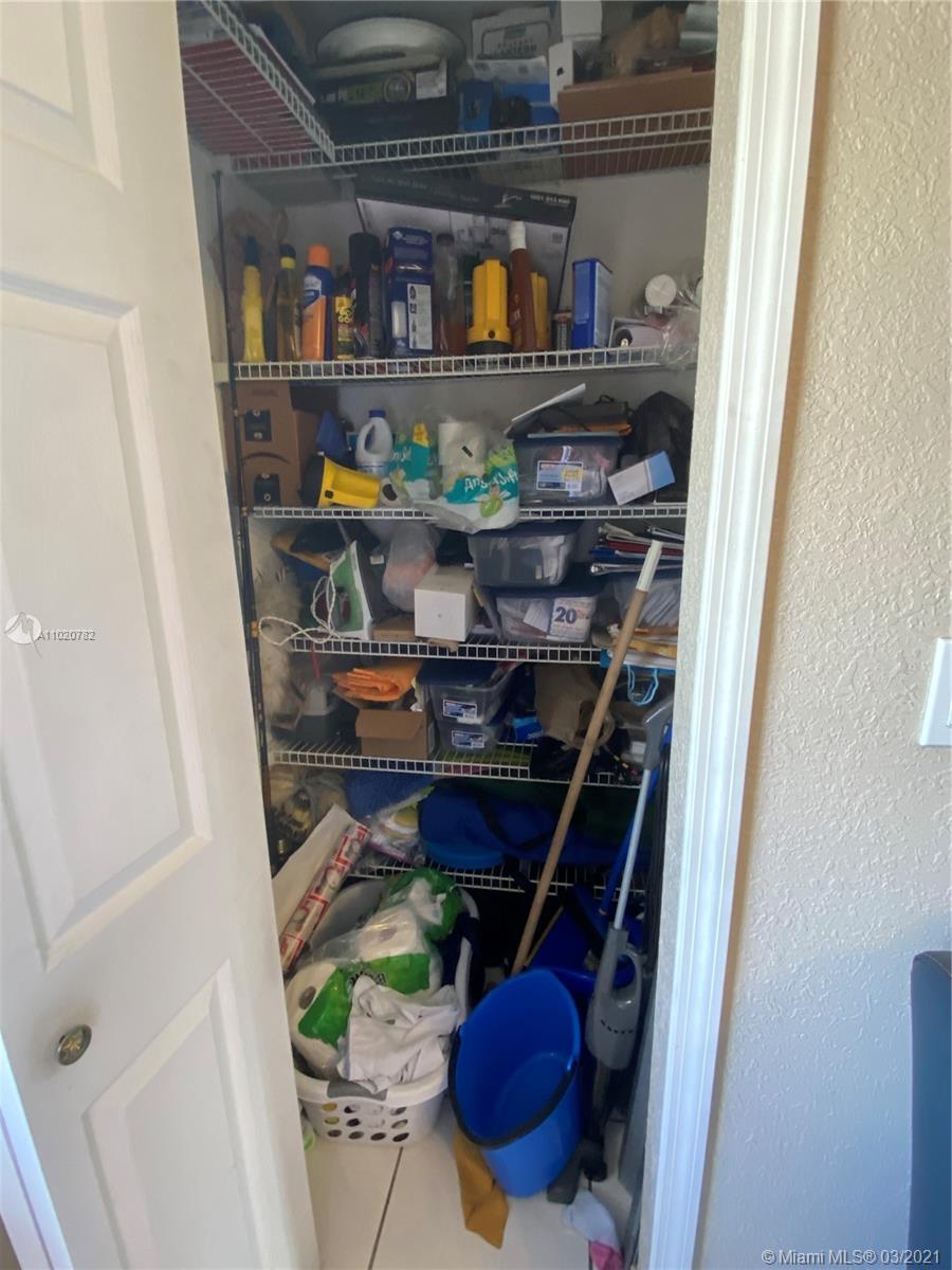 3526 West 76th Street, Unit 203 Hialeah, FL 33018 - Photo 14 of 30 a room with water heater and wooden shelves