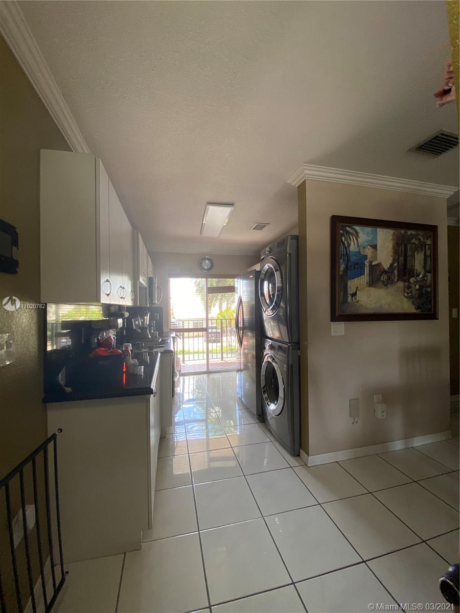 3526 West 76th Street, Unit 203 Hialeah, FL 33018 - Photo 16 of 30 a view of a refrigerator and a car in a room