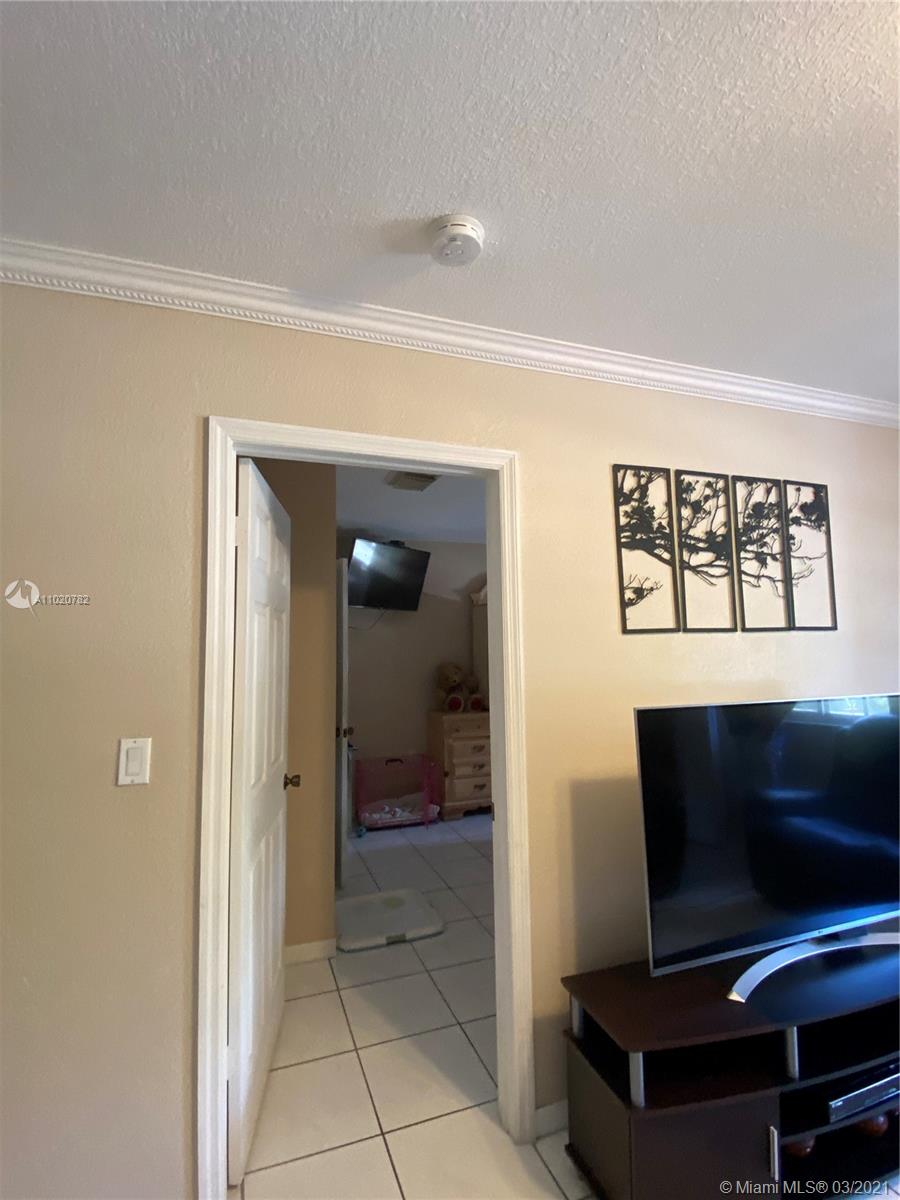 3526 West 76th Street, Unit 203 Hialeah, FL 33018 - Photo 17 of 30 a view of a livingroom with furniture and a flat screen tv