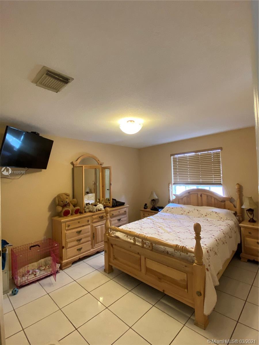 3526 West 76th Street, Unit 203 Hialeah, FL 33018 - Photo 18 of 30 a bedroom with a bed and dresser
