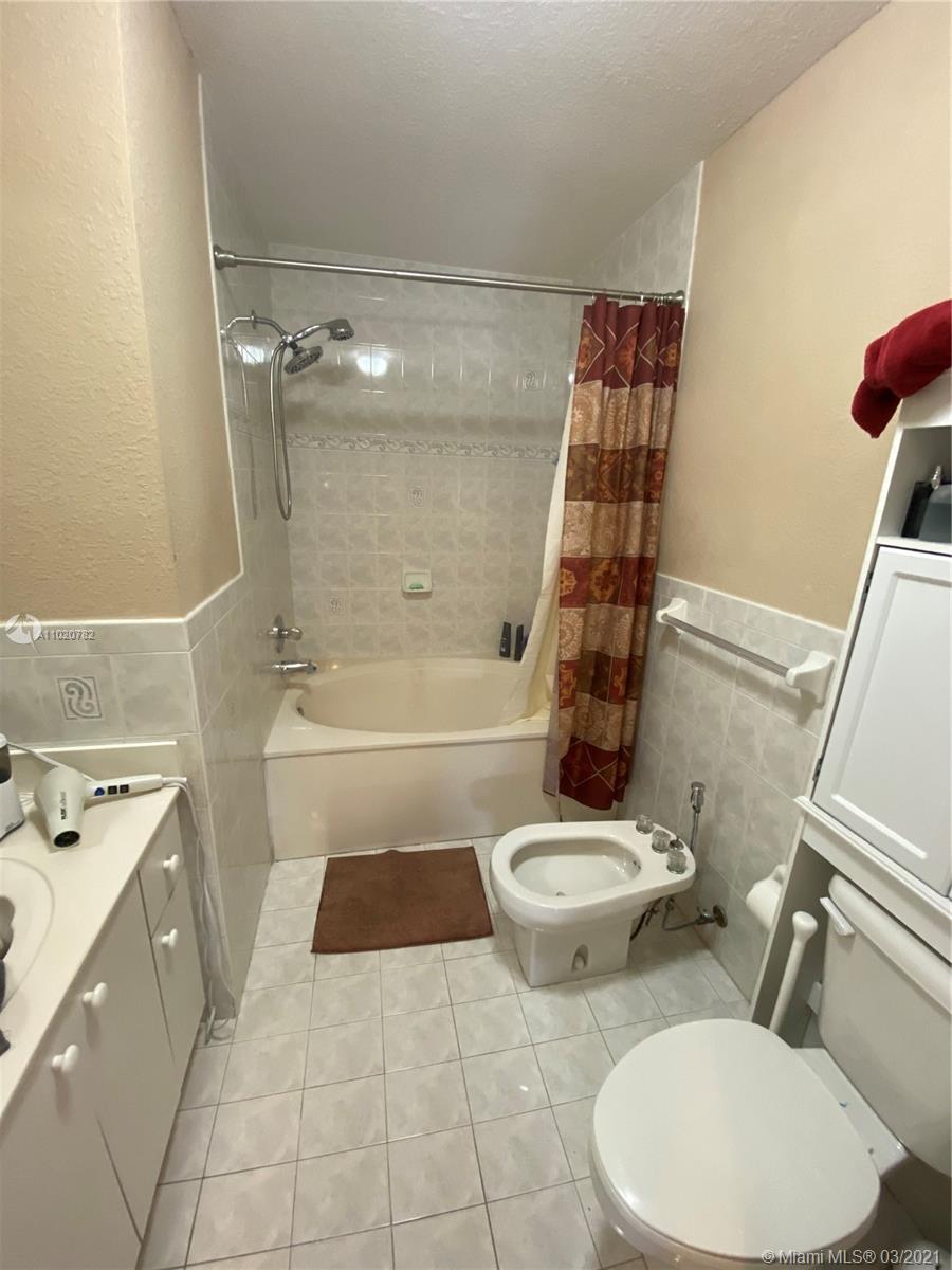 3526 West 76th Street, Unit 203 Hialeah, FL 33018 - Photo 21 of 30 a bathroom with a sink a toilet and shower