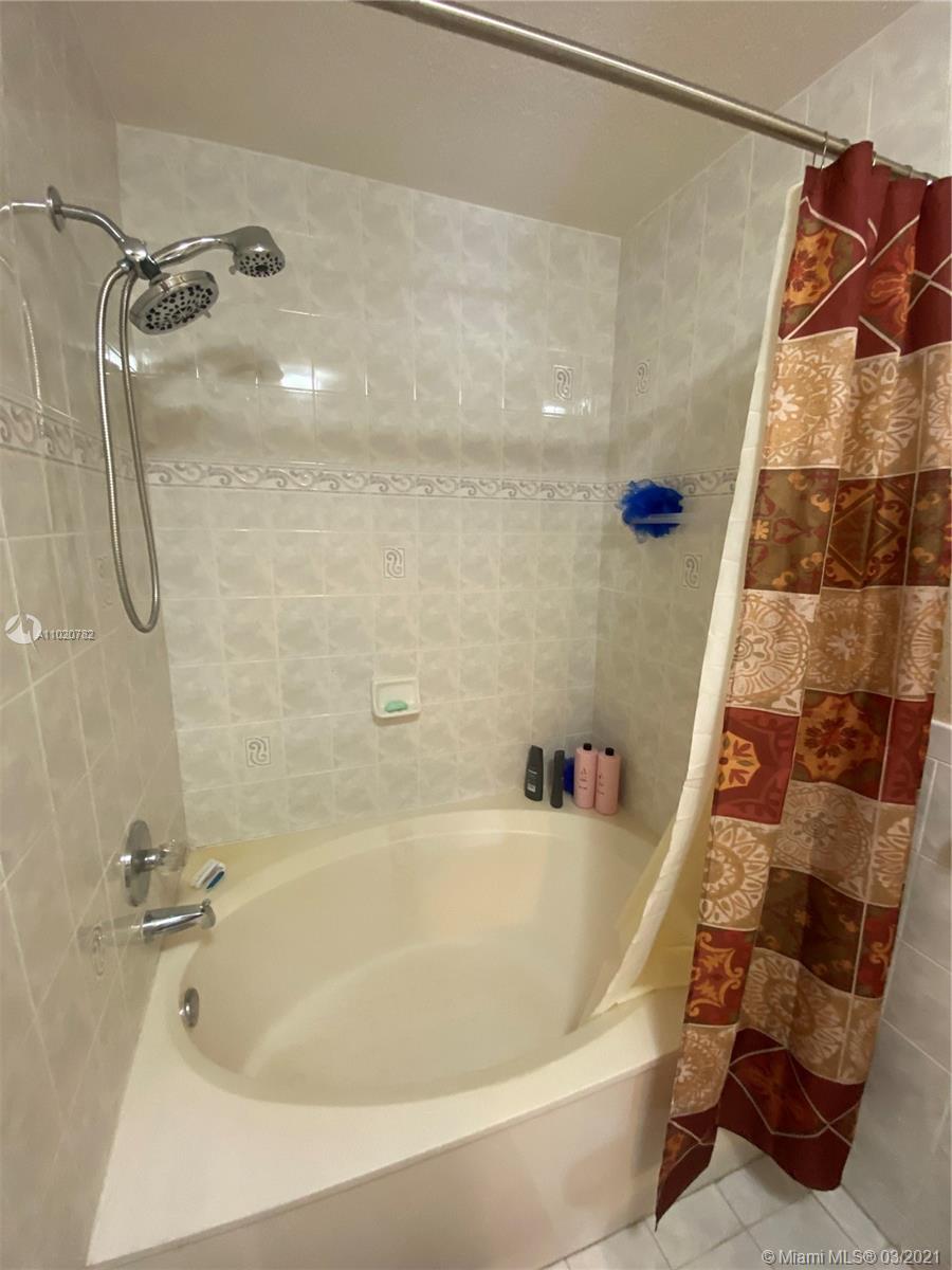 3526 West 76th Street, Unit 203 Hialeah, FL 33018 - Photo 22 of 30 a bathroom with a bath tub and shower