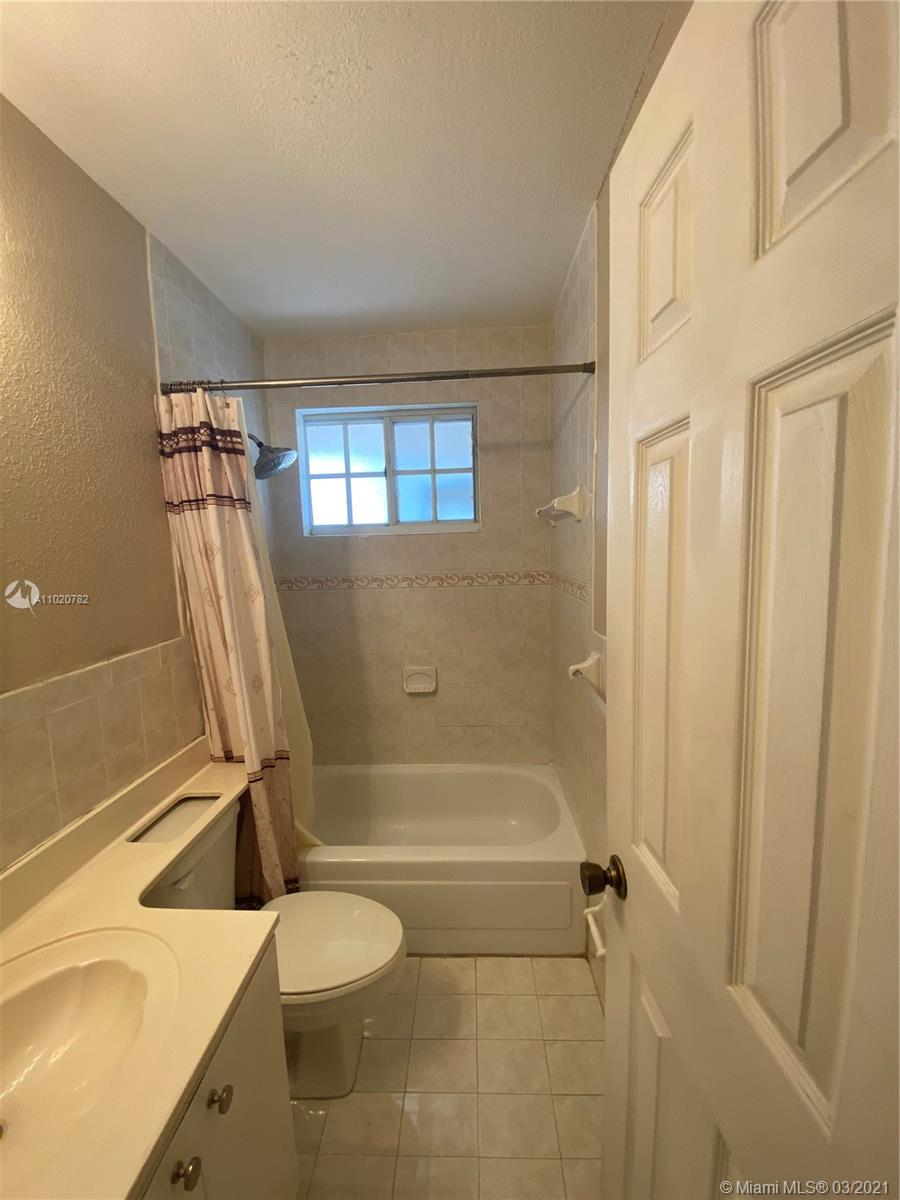 3526 West 76th Street, Unit 203 Hialeah, FL 33018 - Photo 27 of 30 a bathroom with a sink a toilet and shower