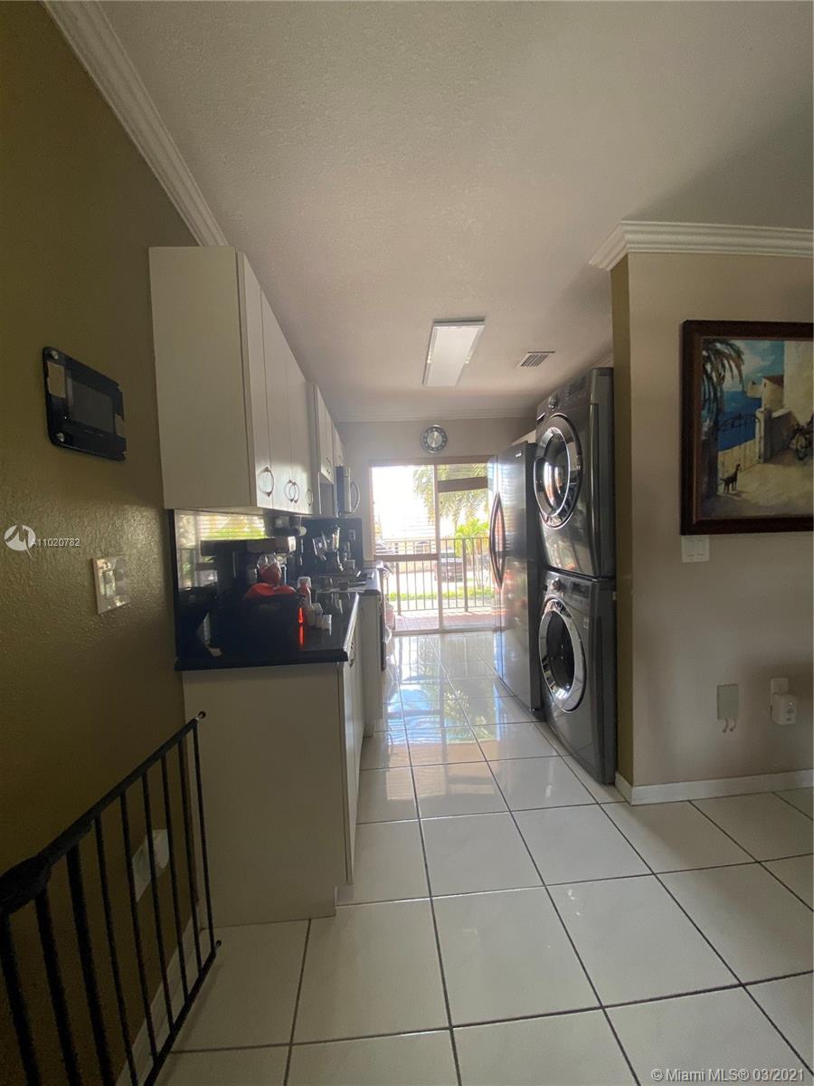 3526 West 76th Street, Unit 203 Hialeah, FL 33018 - Photo 6 of 30 a view of a hallway with washer and dryer