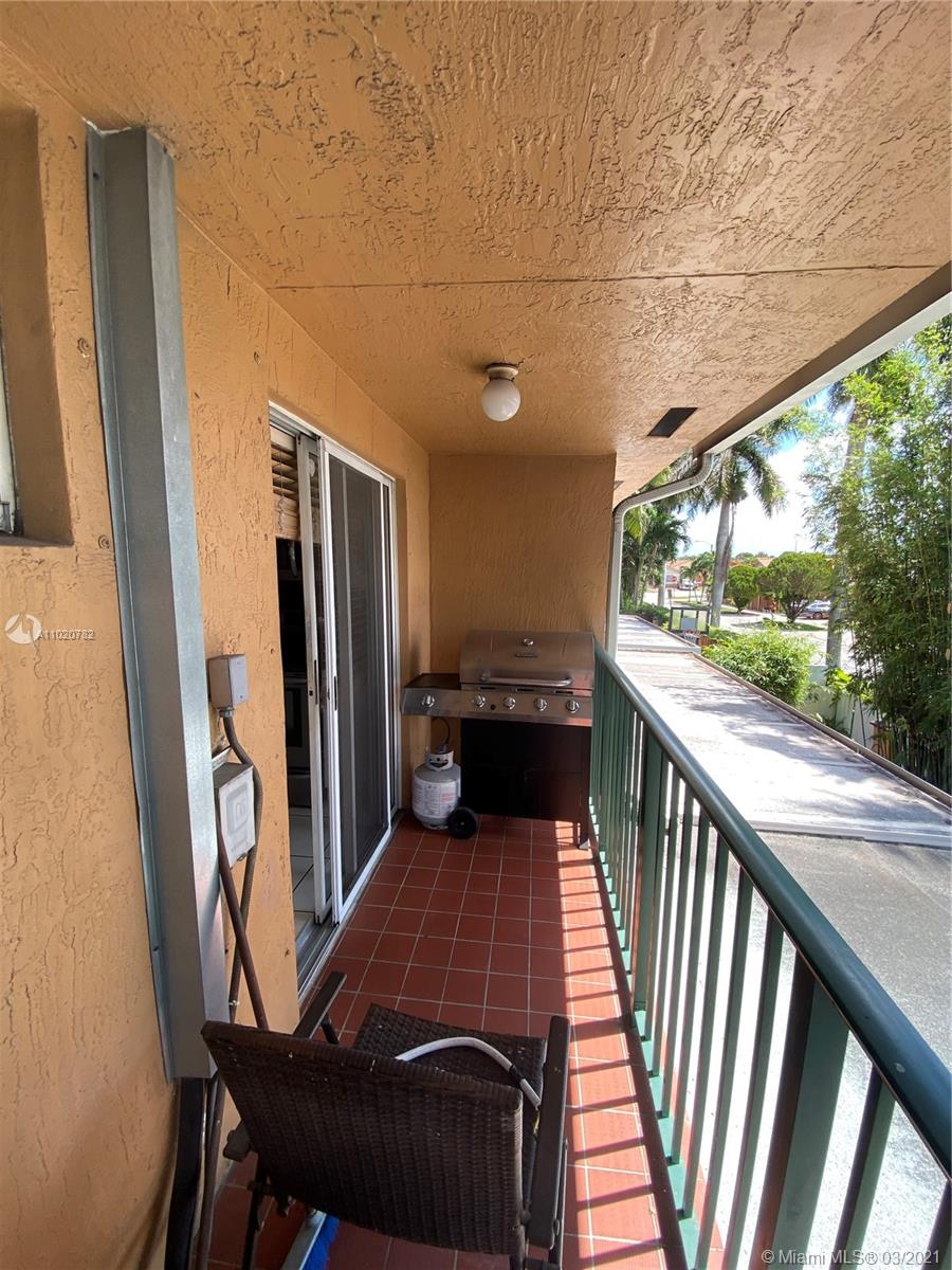 3526 West 76th Street, Unit 203 Hialeah, FL 33018 - Photo 8 of 30 a view of a balcony with wooden floor
