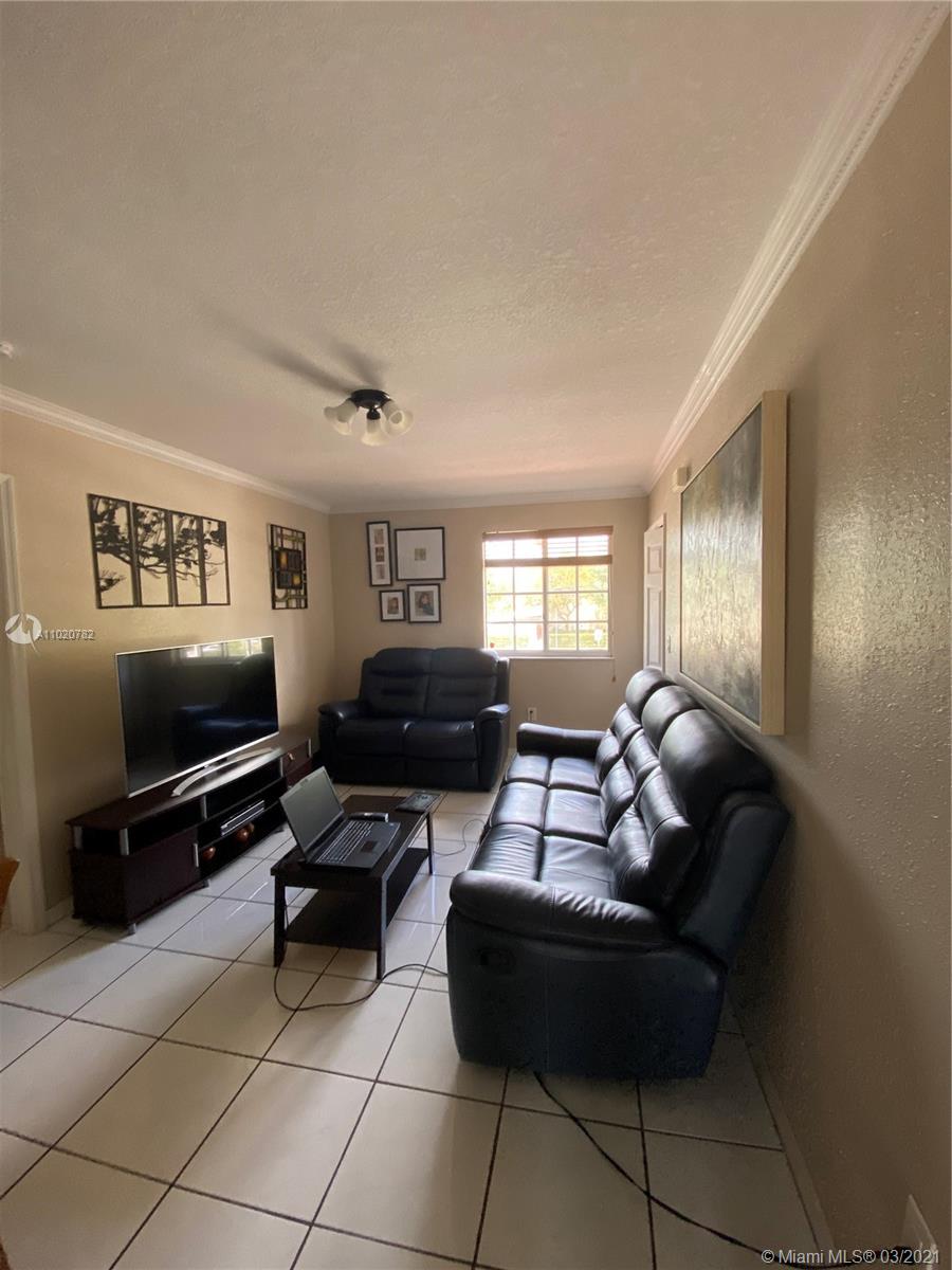 3526 West 76th Street, Unit 203 Hialeah, FL 33018 - Photo 10 of 30 a living room with furniture and a flat screen tv