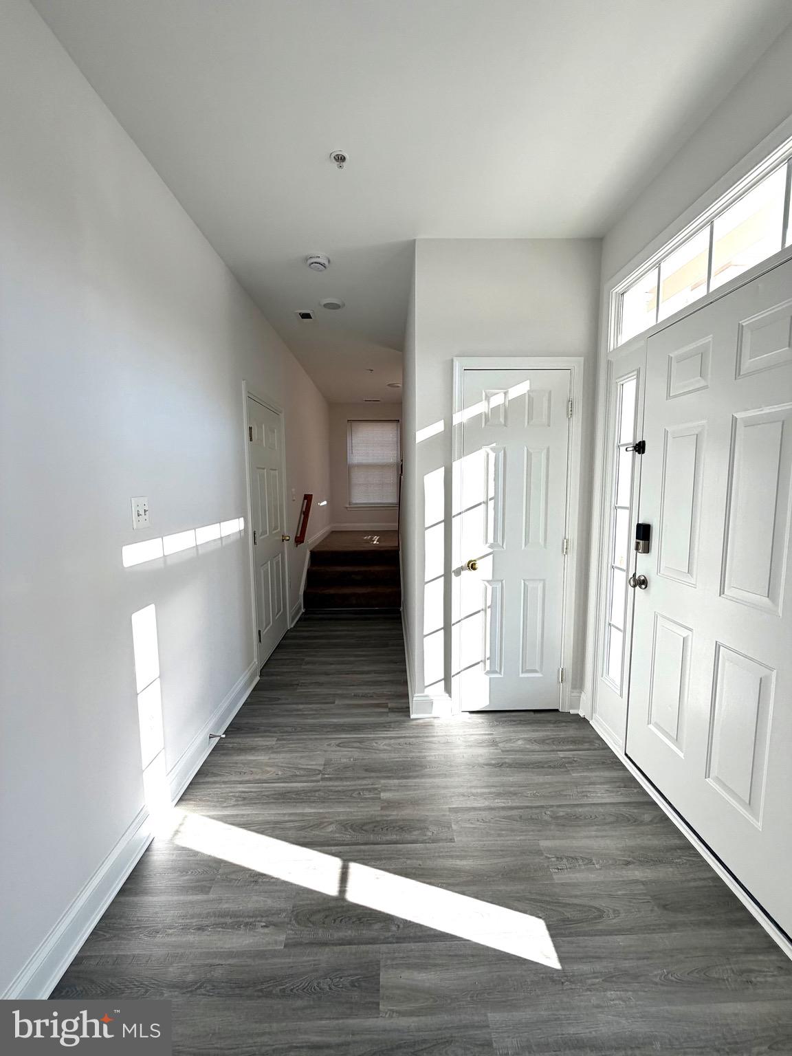 107 A Burck Street, Unit A Frederick, MD 21701 - Photo 6 of 22 a view of a hallway with wooden floor and staircase