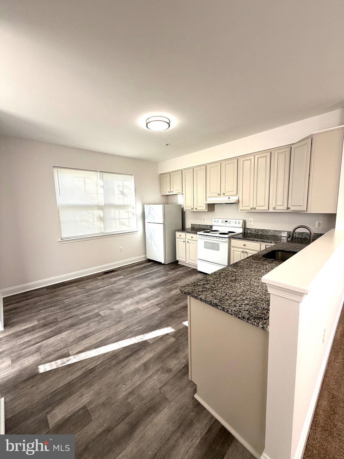 107 A Burck Street, Unit A Frederick, MD 21701 - Photo 10 of 22 a kitchen with stainless steel appliances granite countertop a sink stove and cabinets