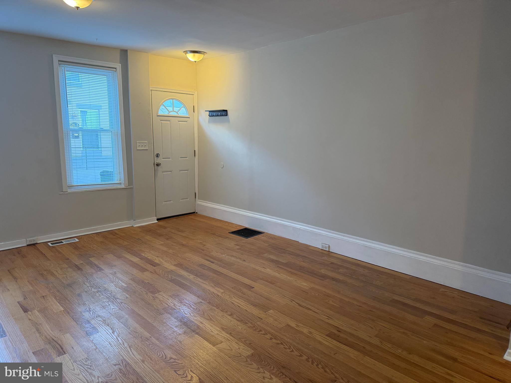 2015 Fernon Street Philadelphia, PA 19145 - Photo 3 of 24 wooden floor in an empty room with a window
