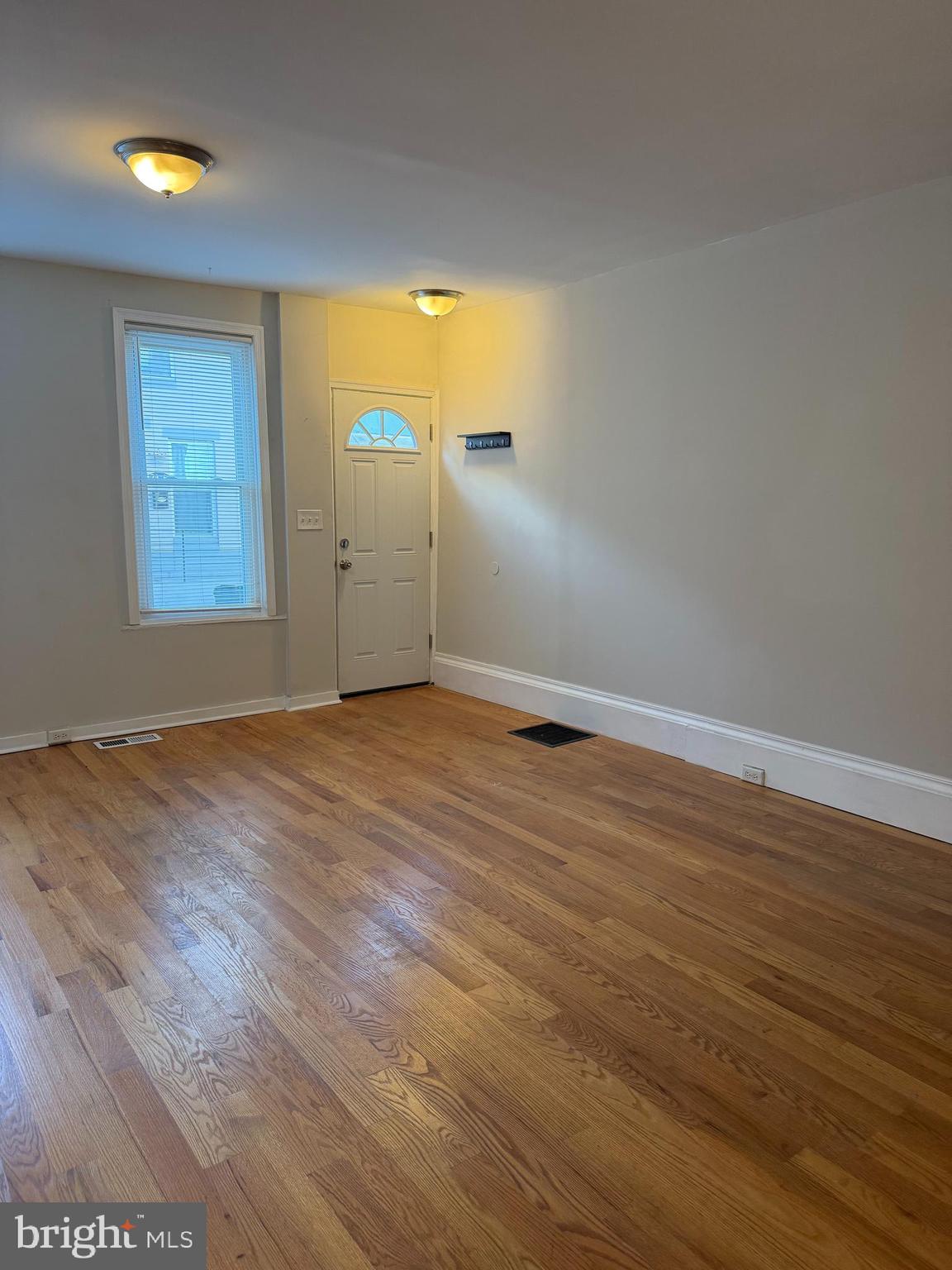 2015 Fernon Street Philadelphia, PA 19145 - Photo 4 of 24 an empty room with wooden floor and windows
