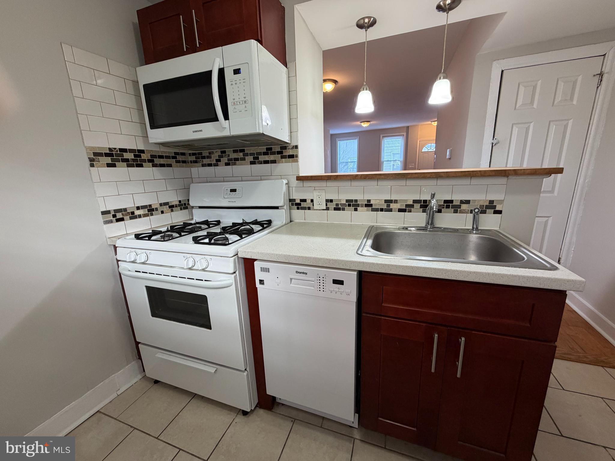 2015 Fernon Street Philadelphia, PA 19145 - Photo 9 of 24 a kitchen with a stove and a microwave