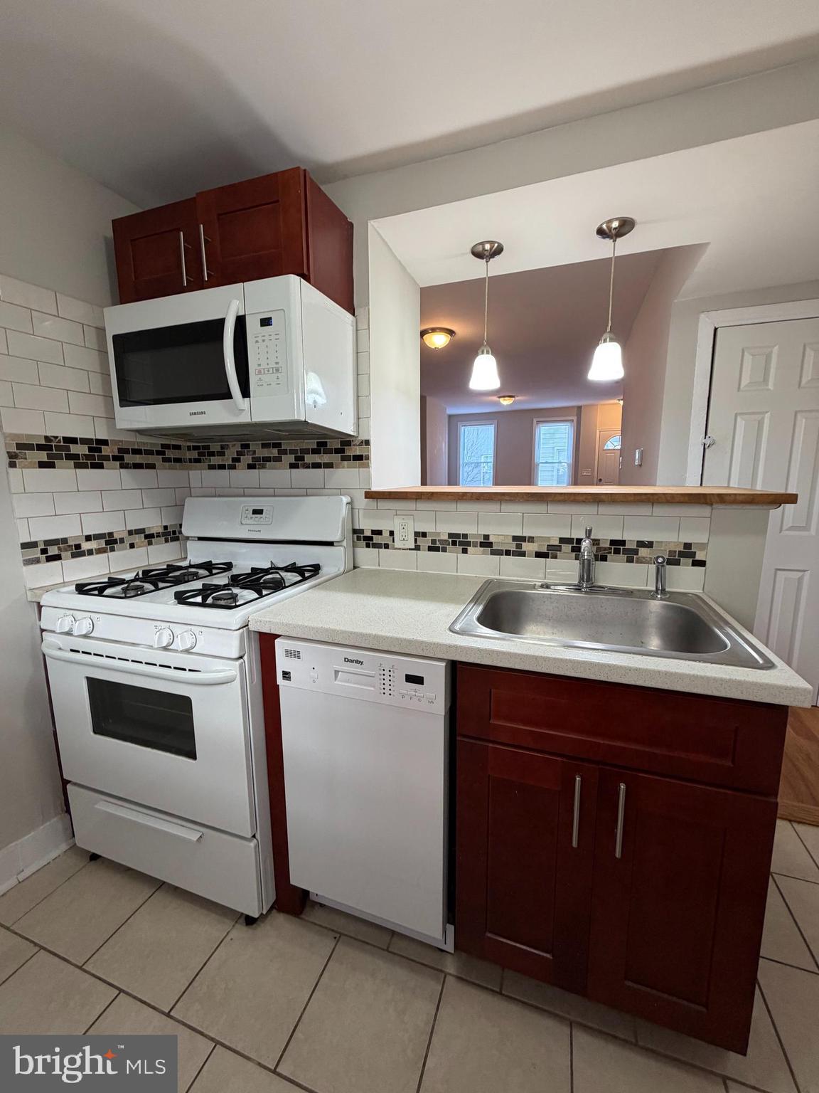 2015 Fernon Street Philadelphia, PA 19145 - Photo 10 of 24 a kitchen with stainless steel appliances a stove a sink and a microwave