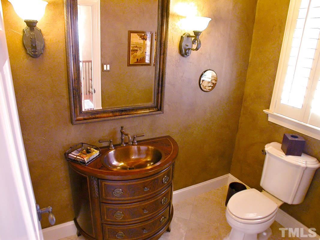 12200 Lockhart Lane Raleigh, NC 27614 - Photo 15 of 25 1st floor half bath offers unique copper sink and copper ceiling coupled by a tumbled marble floor, setting the stage for many inspired conversations.