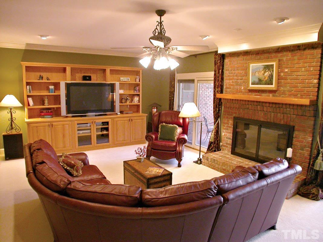 12200 Lockhart Lane Raleigh, NC 27614 - Photo 18 of 25 Lower level "daylight" family room personifies entertaining and endearing evenings by the fireplace. 2 sets of Pella sliding doors open to a lower level patio for relaxing!
