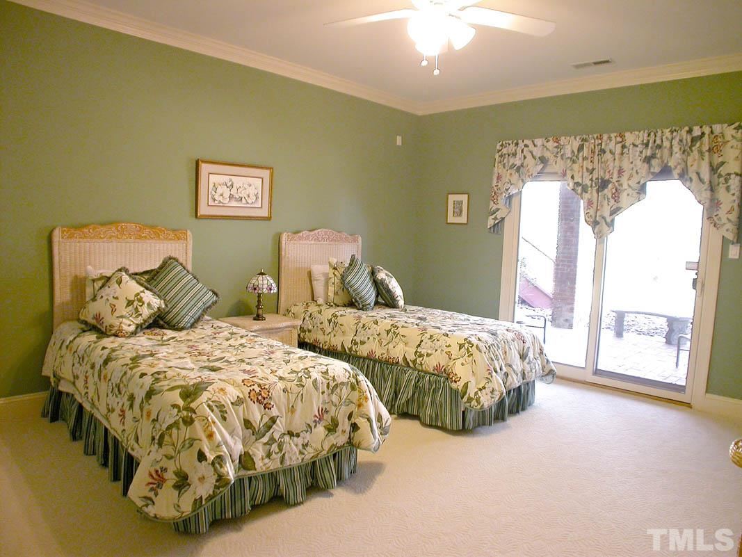 12200 Lockhart Lane Raleigh, NC 27614 - Photo 20 of 25 Bedrooms separated by an updated Jack & Jill bathroom include high quartz vanity counters, Walk-in closet and Pella door opening onto lower level patio.