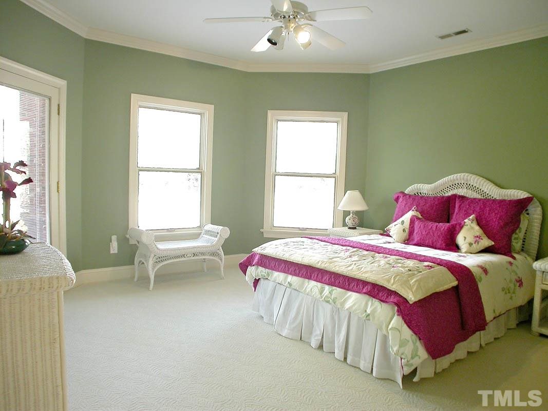 12200 Lockhart Lane Raleigh, NC 27614 - Photo 21 of 25 The lower level bedroom has an amazing view of the backyard with lots of light and a door to the outside patio! The wall to wall carpets are light colored and in pristine condition!