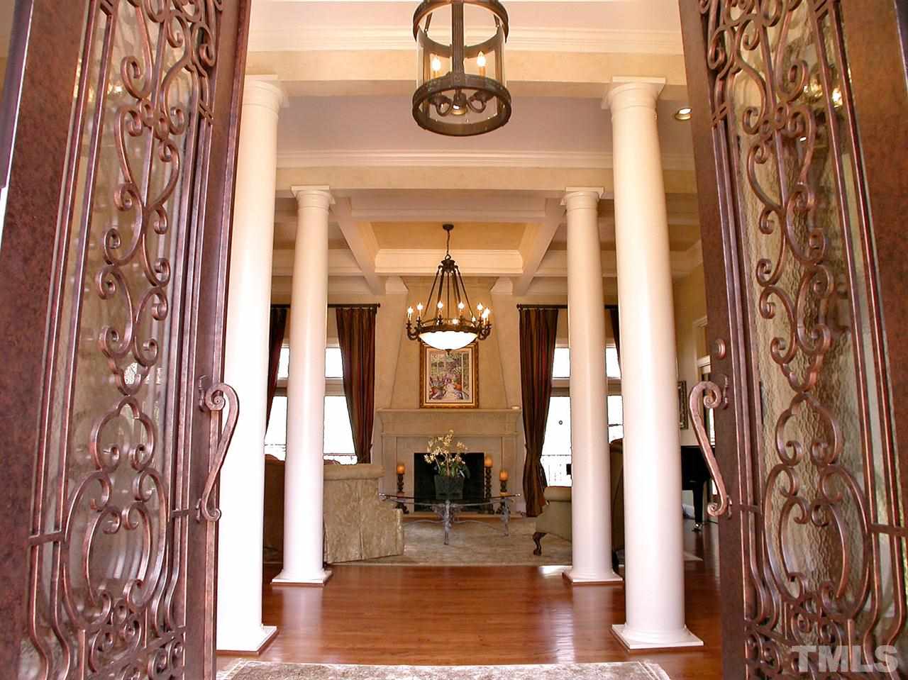 12200 Lockhart Lane Raleigh, NC 27614 - Photo 4 of 25 Welcome home to exquisite style & elegance. A dramatic Cantera Esperanza wrought iron double door entry bids a warm reception to a stately living room.