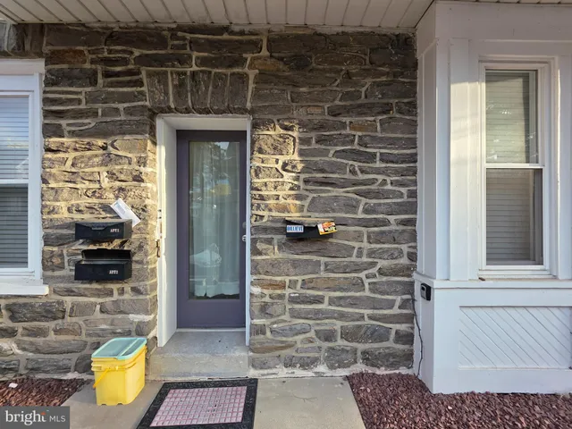 a view of front door of house and outdoor space