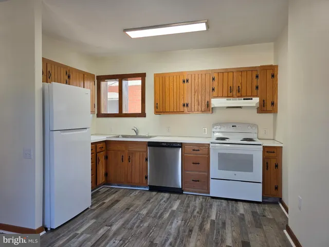 a kitchen with a stove a sink and a refrigerator