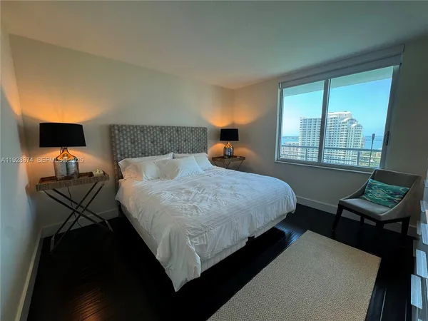 a bed sitting in a bedroom next to a window