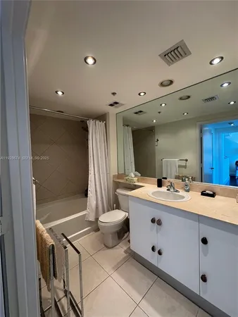 a bathroom with a double vanity sink toilet and mirror