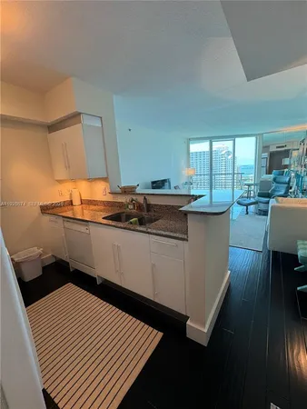 a kitchen with a sink and wooden cabinets