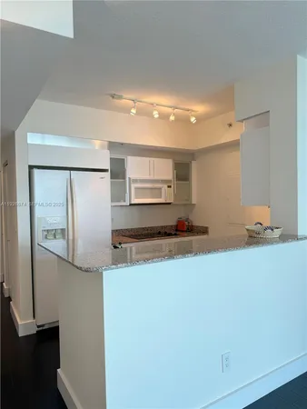 a kitchen with stainless steel appliances a refrigerator and a stove