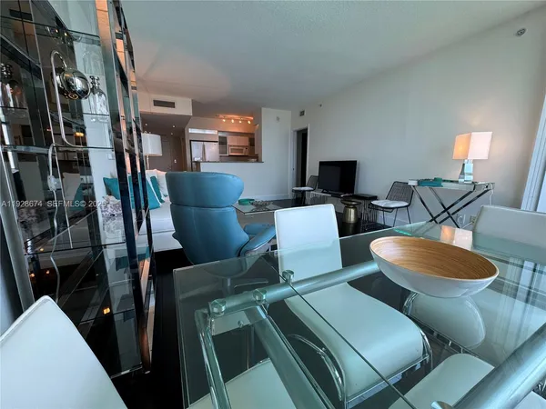 a dining room with furniture and a flat screen tv