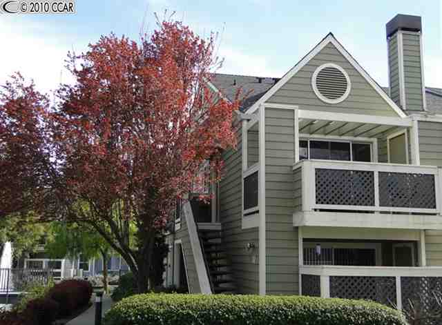 115 Reflections Drive, Unit 21 San Ramon, CA 94583 - Photo 1 of 1 a front view of a house with garage and trees