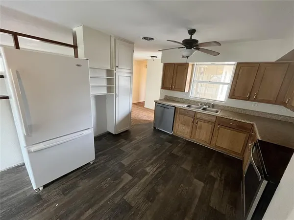 a kitchen with stainless steel appliances a refrigerator and a refrigerator